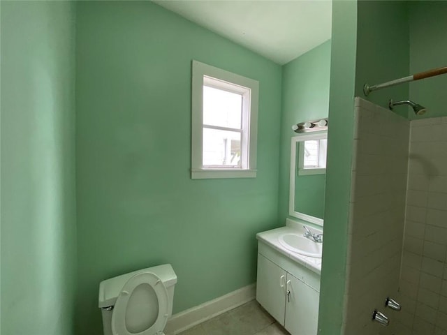 3321 Baronne St, New Orleans, LA 70113 - bathroom featuring toilet, vanity, tile patterned flooring, walk in shower, and baseboards