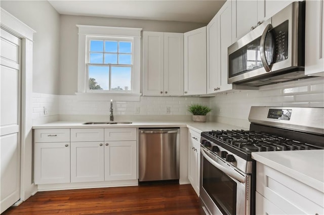 441921 Fontainebleau Dr, New Orleans, LA 70125 - kitchen with light countertops, white cabinets, appliances with stainless steel finishes, dark wood-type flooring, and a sink