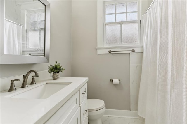 441921 Fontainebleau Dr, New Orleans, LA 70125 - full bath with marble finish floor, toilet, baseboards, and a wealth of natural light