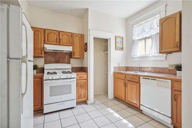 441921 Fontainebleau Dr, New Orleans, LA 70125 - kitchen with tile counters, white appliances, under cabinet range hood, a sink, and light tile patterned flooring