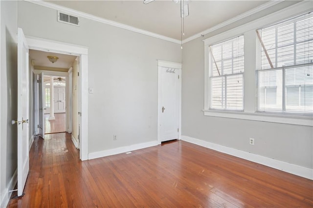 441921 Fontainebleau Dr, New Orleans, LA 70125 - interior space featuring hardwood / wood-style flooring, multiple windows, baseboards, visible vents, and ornamental molding