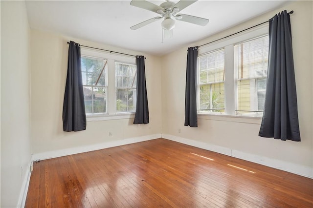 441921 Fontainebleau Dr, New Orleans, LA 70125 - spare room with hardwood / wood-style floors, ceiling fan, baseboards, and plenty of natural light