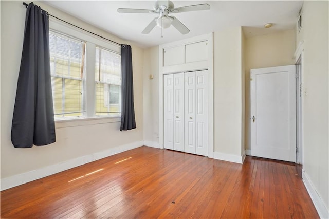 441921 Fontainebleau Dr, New Orleans, LA 70125 - unfurnished bedroom featuring a closet, visible vents, baseboards, ceiling fan, and hardwood / wood-style floors