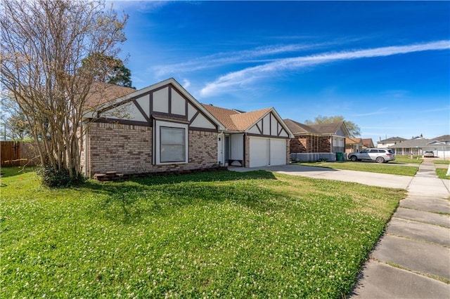 2260 Killington Dr, Harvey, LA 70058 - tudor house featuring fence, driveway, a front yard, brick siding, and a garage