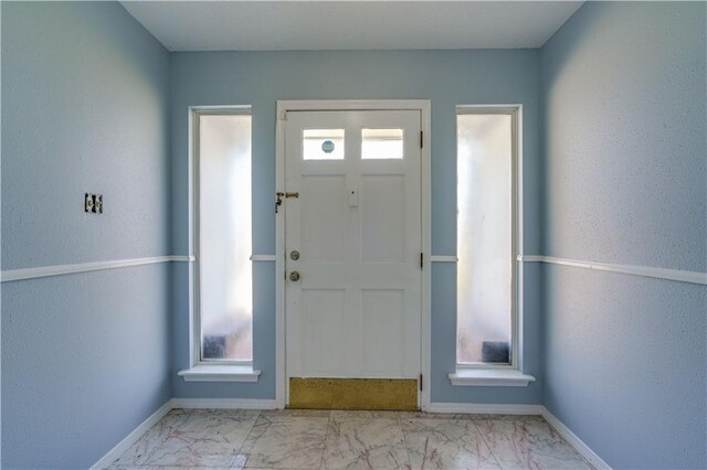2260 Killington Dr, Harvey, LA 70058 - foyer entrance featuring marble finish floor, a wealth of natural light, and baseboards