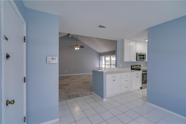 2260 Killington Dr, Harvey, LA 70058 - kitchen with lofted ceiling with beams, open floor plan, stainless steel appliances, white cabinets, and ceiling fan