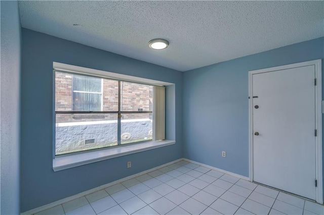2260 Killington Dr, Harvey, LA 70058 - unfurnished room with baseboards, light tile patterned floors, and a textured ceiling