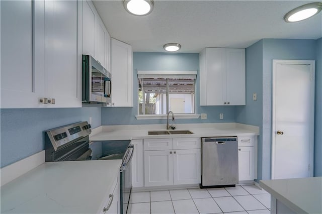2260 Killington Dr, Harvey, LA 70058 - kitchen with white cabinetry, light countertops, a sink, and appliances with stainless steel finishes