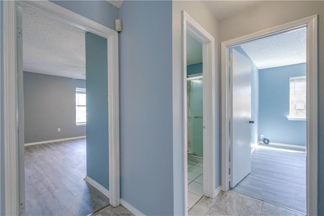 2260 Killington Dr, Harvey, LA 70058 - hallway with wood finished floors, baseboards, and a textured ceiling