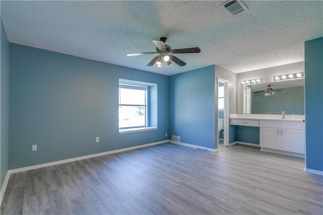 2260 Killington Dr, Harvey, LA 70058 - unfurnished bedroom with light wood-style flooring, a sink, and visible vents