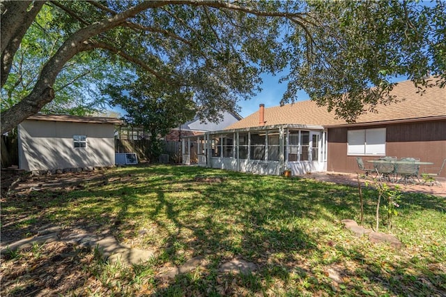 2260 Killington Dr, Harvey, LA 70058 - view of yard featuring an outdoor structure, a sunroom, fence, and a patio
