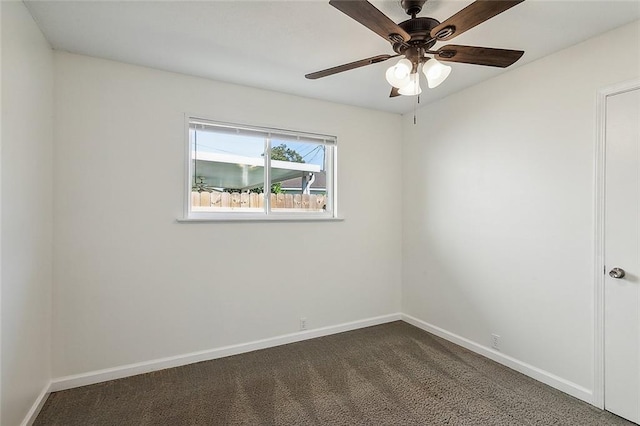 545 Brookmeade Dr, Gretna, LA 70056 - spare room featuring dark carpet, baseboards, and a ceiling fan