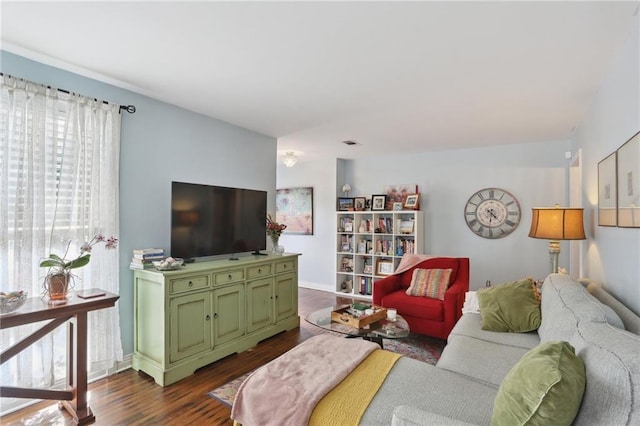 3701 Marigny St, New Orleans, LA 70122 - living room featuring baseboards, visible vents, and dark wood finished floors