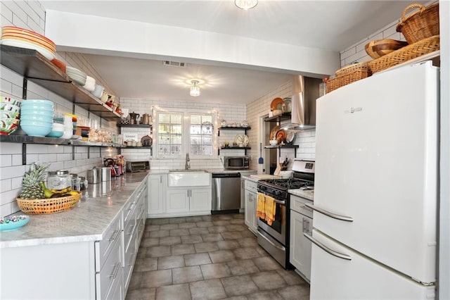 3701 Marigny St, New Orleans, LA 70122 - kitchen with a sink, backsplash, open shelves, appliances with stainless steel finishes, and wall chimney range hood