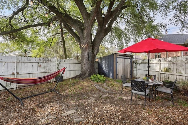 3701 Marigny St, New Orleans, LA 70122 - view of yard with a storage unit, a fenced backyard, and an outdoor structure