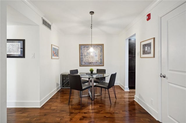 1430 Jackson Ave Unit 205, New Orleans, LA 70130 - dining area with baseboards, dark wood finished floors, and crown molding