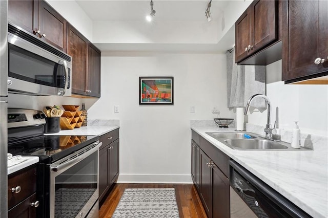 1430 Jackson Ave Unit 205, New Orleans, LA 70130 - kitchen with appliances with stainless steel finishes, a sink, dark wood-type flooring, dark brown cabinetry, and baseboards