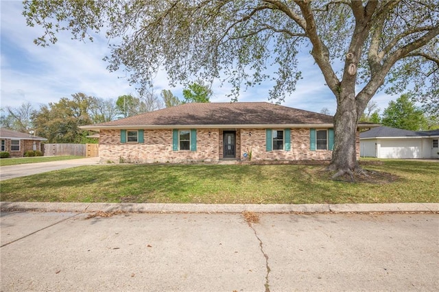128 Belle Grove Dr, La Place, LA 70068 - ranch-style home featuring brick siding, fence, concrete driveway, and a front yard