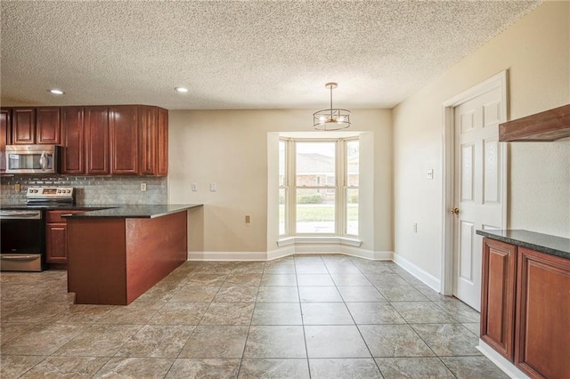 128 Belle Grove Dr, La Place, LA 70068 - kitchen featuring dark countertops, decorative backsplash, appliances with stainless steel finishes, and a peninsula