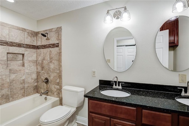 128 Belle Grove Dr, La Place, LA 70068 - bathroom with double vanity, a textured ceiling, a sink, and toilet