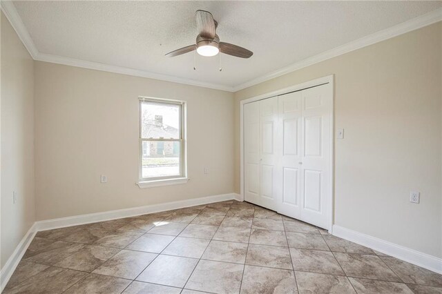 128 Belle Grove Dr, La Place, LA 70068 - unfurnished bedroom with light tile patterned floors, ornamental molding, baseboards, ceiling fan, and a closet