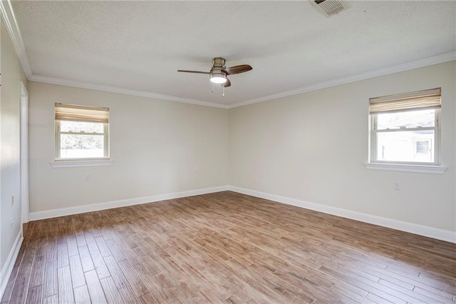 128 Belle Grove Dr, La Place, LA 70068 - spare room featuring ornamental molding, baseboards, ceiling fan, visible vents, and wood finished floors