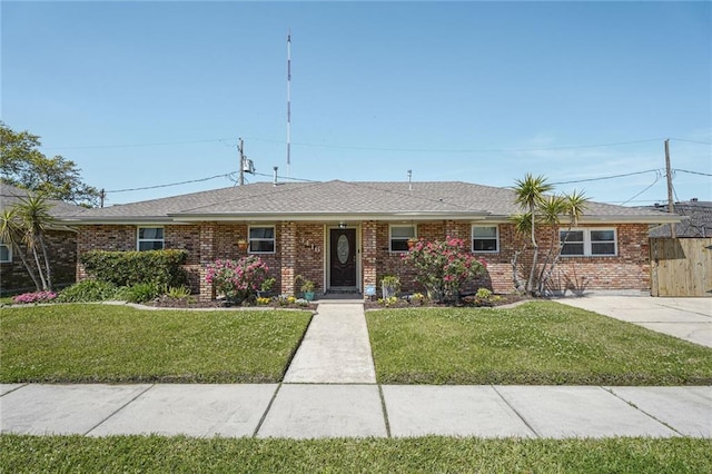 ranch-style home with brick siding and a front yard