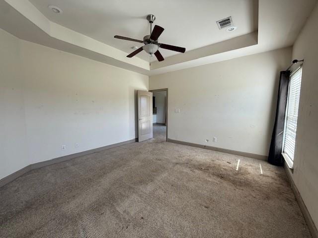 17657 Golden Eagle Dr, Prairieville, LA 70769 - unfurnished room with carpet floors, a healthy amount of sunlight, ceiling fan, and a raised ceiling