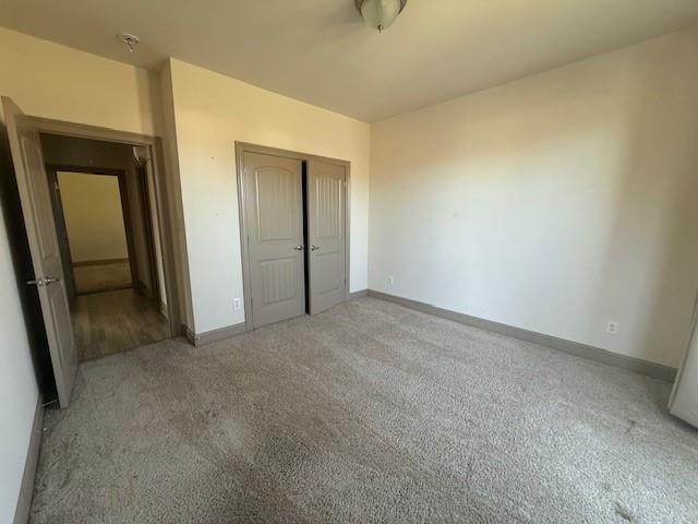 17657 Golden Eagle Dr, Prairieville, LA 70769 - unfurnished bedroom featuring baseboards, a closet, and carpet floors