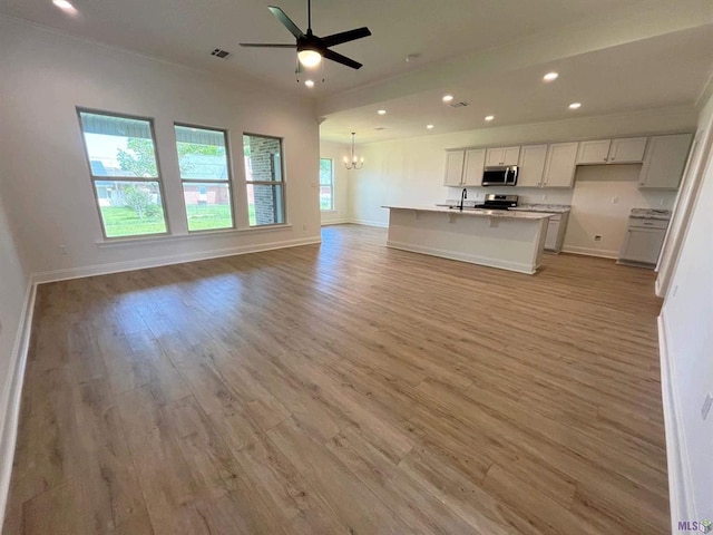 129 Olivia Dr, Luling, LA 70070 - unfurnished living room featuring recessed lighting, a chandelier, light wood-style floors, and a ceiling fan