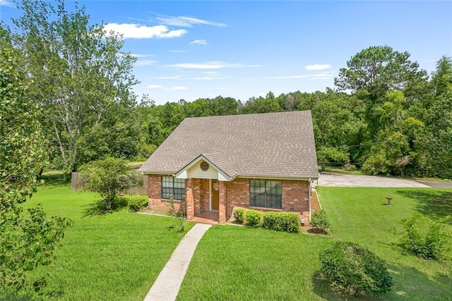 65398 Maple St, Mandeville, LA 70448 - view of front facade with brick siding and a front lawn