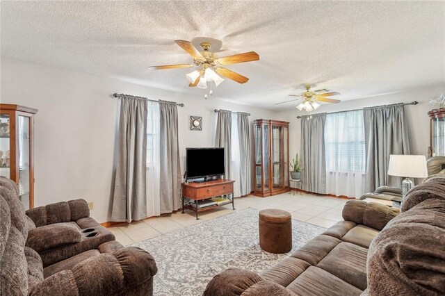 65398 Maple St, Mandeville, LA 70448 - living area featuring light tile patterned flooring, a ceiling fan, and a textured ceiling