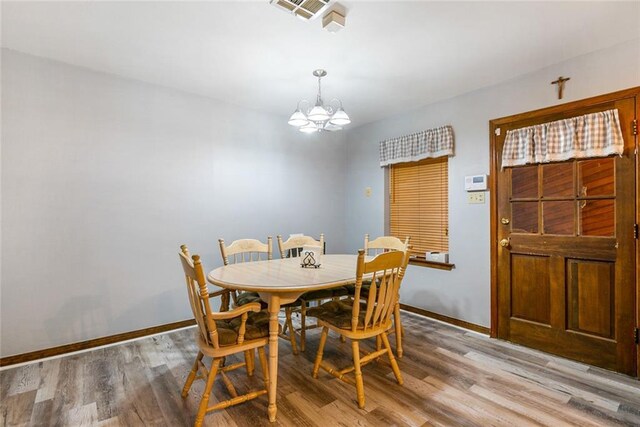 65398 Maple St, Mandeville, LA 70448 - dining room featuring a chandelier, baseboards, and light wood finished floors