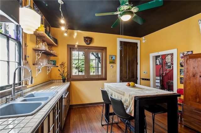 3342 Bell St, New Orleans, LA 70119 - kitchen with a sink, open shelves, tile counters, ceiling fan, and dark wood-style flooring