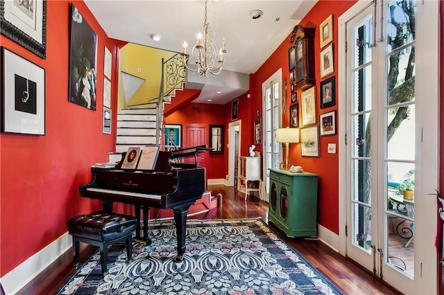 3342 Bell St, New Orleans, LA 70119 - sitting room featuring baseboards, stairs, wood finished floors, and an inviting chandelier