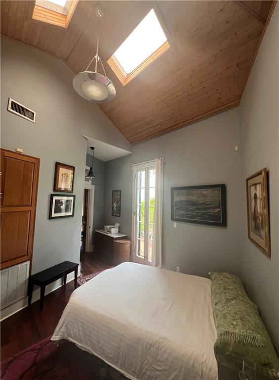 3342 Bell St, New Orleans, LA 70119 - bedroom with wood finished floors, wooden ceiling, vaulted ceiling with skylight, and visible vents