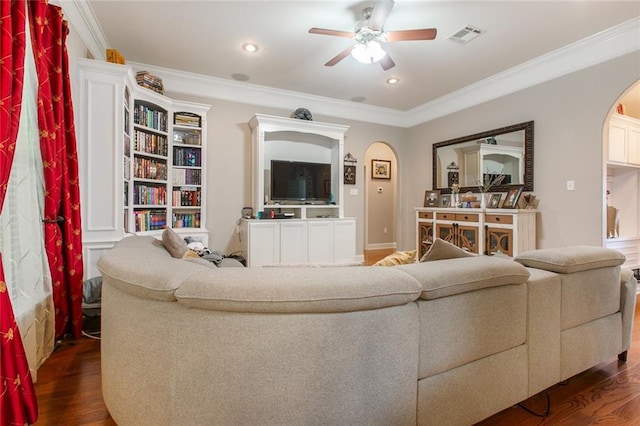 living area featuring visible vents, ceiling fan, crown molding, dark wood-style flooring, and arched walkways