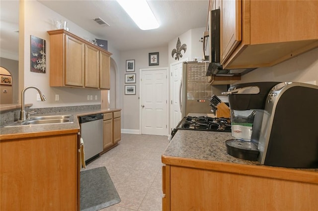 kitchen featuring a sink, light tile patterned flooring, visible vents, stainless steel dishwasher, and baseboards