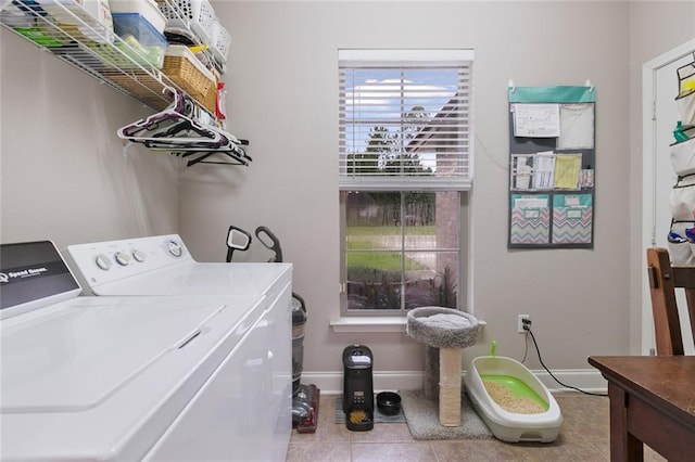 washroom with washing machine and dryer, laundry area, baseboards, and tile patterned flooring