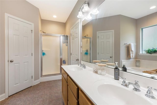 full bath with a shower stall, tile patterned flooring, double vanity, and a sink