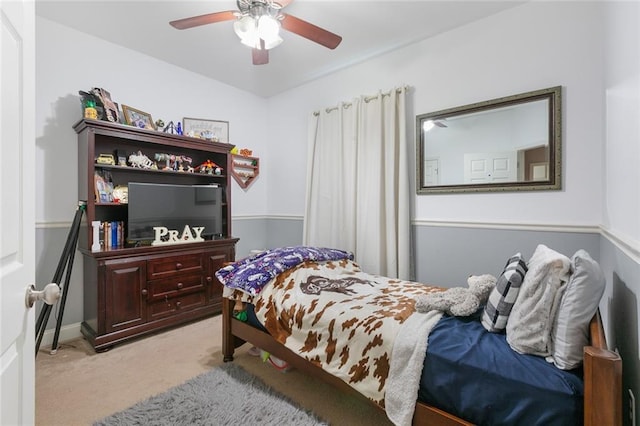 bedroom with a ceiling fan and light colored carpet
