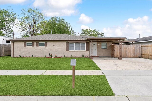 3013 Volpe Dr, Chalmette, LA 70043 - ranch-style home with brick siding, a front lawn, fence, and concrete driveway