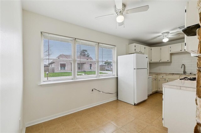 3013 Volpe Dr, Chalmette, LA 70043 - kitchen featuring ceiling fan, a sink, white appliances, light countertops, and tasteful backsplash
