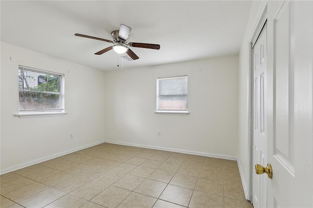3013 Volpe Dr, Chalmette, LA 70043 - unfurnished bedroom featuring light tile patterned flooring, baseboards, a ceiling fan, and a closet