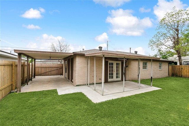 3013 Volpe Dr, Chalmette, LA 70043 - rear view of property featuring a yard, brick siding, french doors, and a fenced backyard