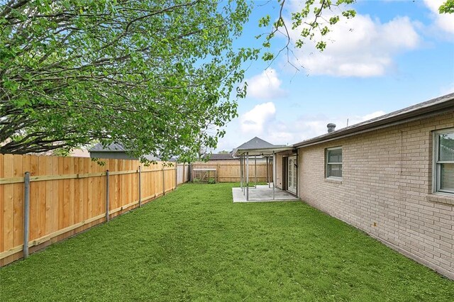3013 Volpe Dr, Chalmette, LA 70043 - view of yard featuring a patio and a fenced backyard