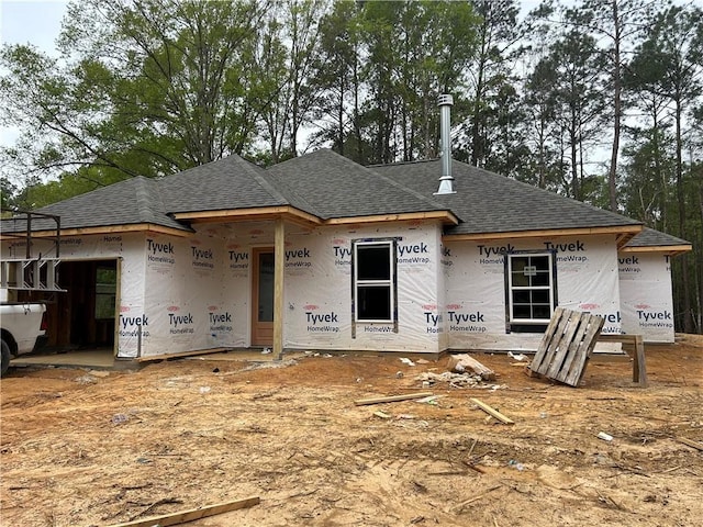 property in mid-construction with roof with shingles