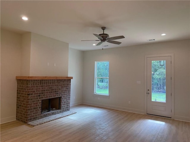 75396 Henderson Rd, Covington, LA 70435 - unfurnished living room featuring wood finished floors, ceiling fan, a brick fireplace, and recessed lighting