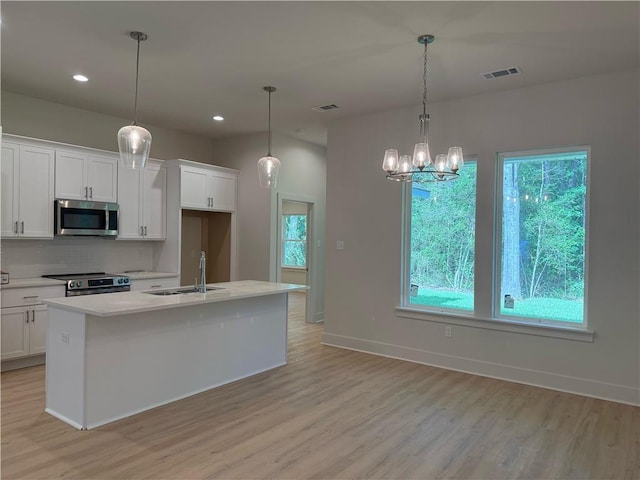 75396 Henderson Rd, Covington, LA 70435 - kitchen with stainless steel appliances, backsplash, healthy amount of natural light, light countertops, and recessed lighting