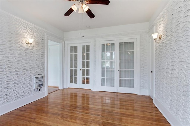 4237 Fontainebleau Dr, New Orleans, LA 70125 - empty room featuring ceiling fan, wood finished floors, and french doors